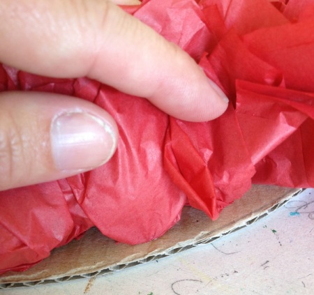 Keep glueing tissue squares as closely to the outer edge as you can